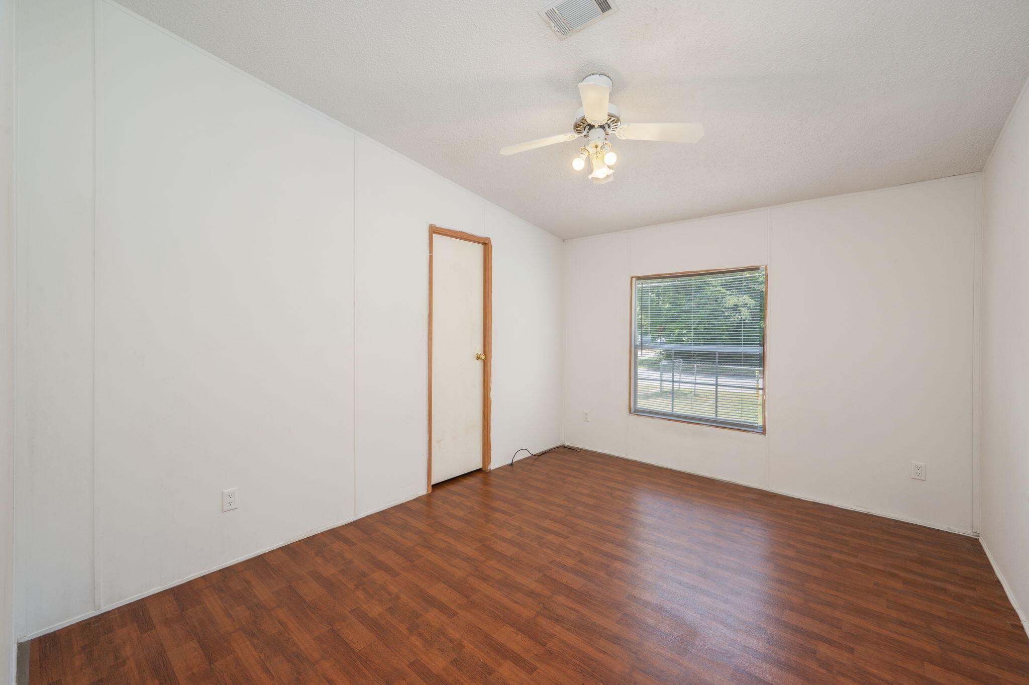 189 Benjamin Street Crestview, FL 32536 - Photo 27 of 40 wooden floor in an empty room with a window