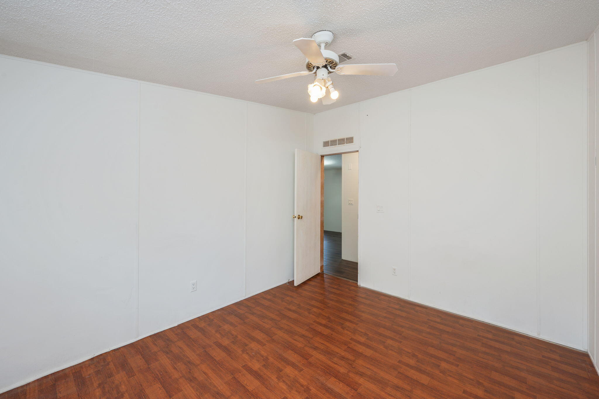 189 Benjamin Street Crestview, FL 32536 - Photo 28 of 40 a view of an empty room with wooden floor