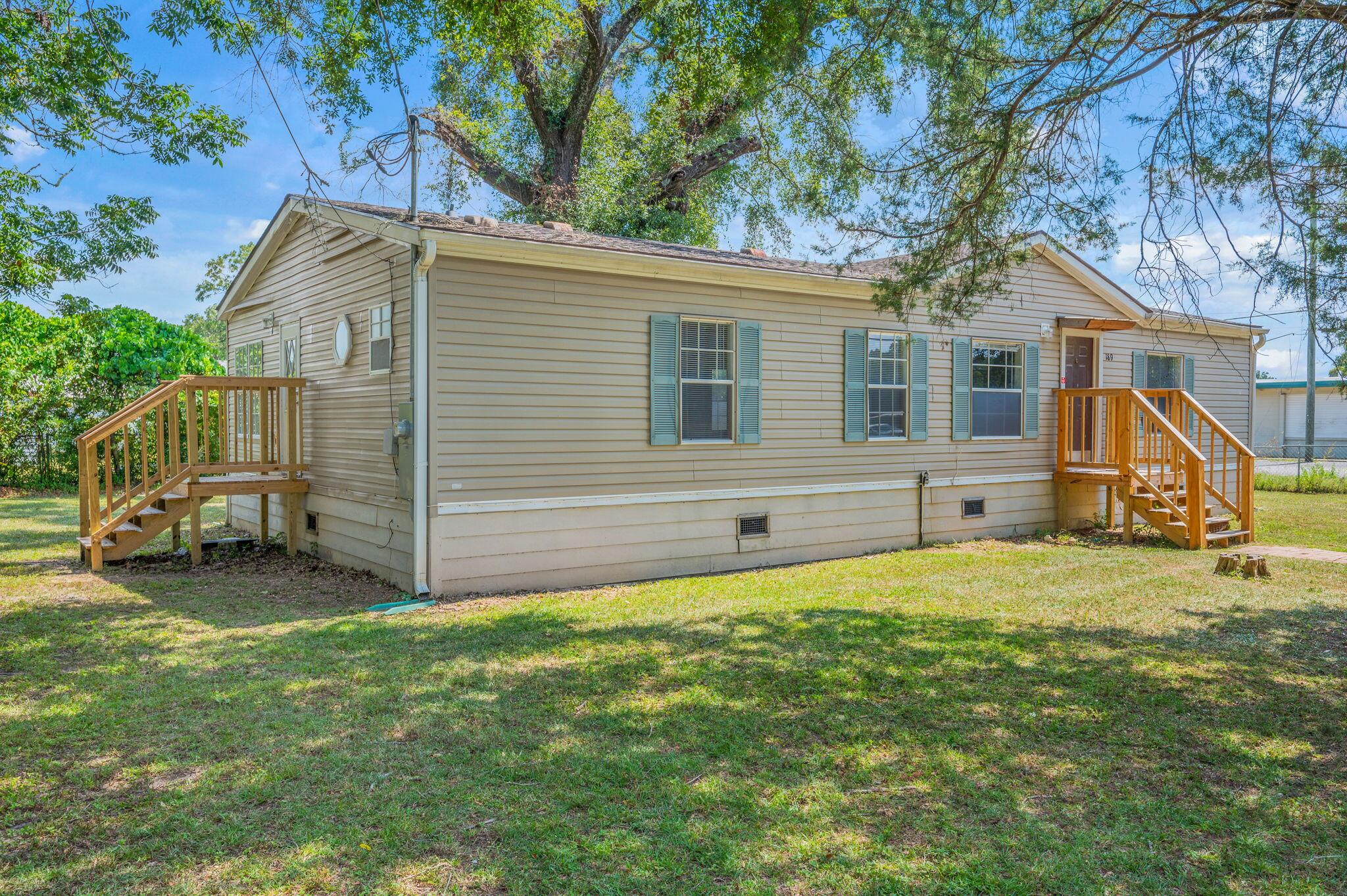189 Benjamin Street Crestview, FL 32536 - Photo 3 of 40 a backyard of a house with barbeque oven and table and chairs