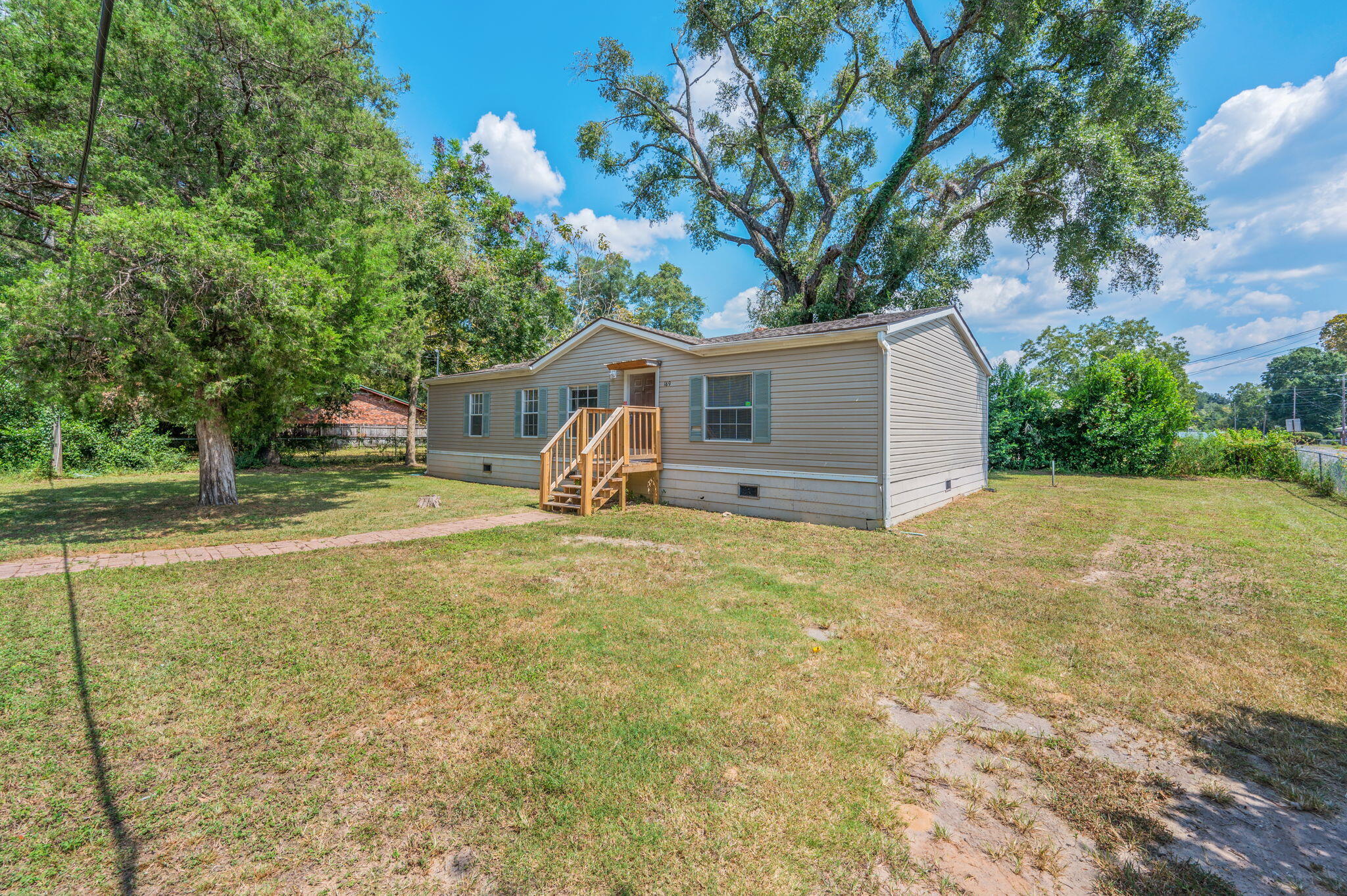189 Benjamin Street Crestview, FL 32536 - Photo 4 of 40 a view of a house with a yard and garage