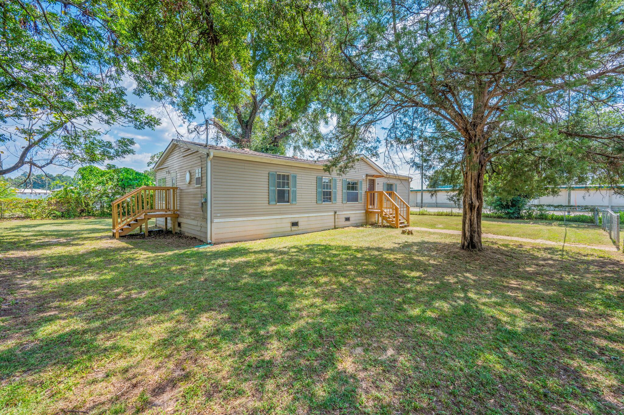 189 Benjamin Street Crestview, FL 32536 - Photo 5 of 40 a view of a house with backyard and a tree