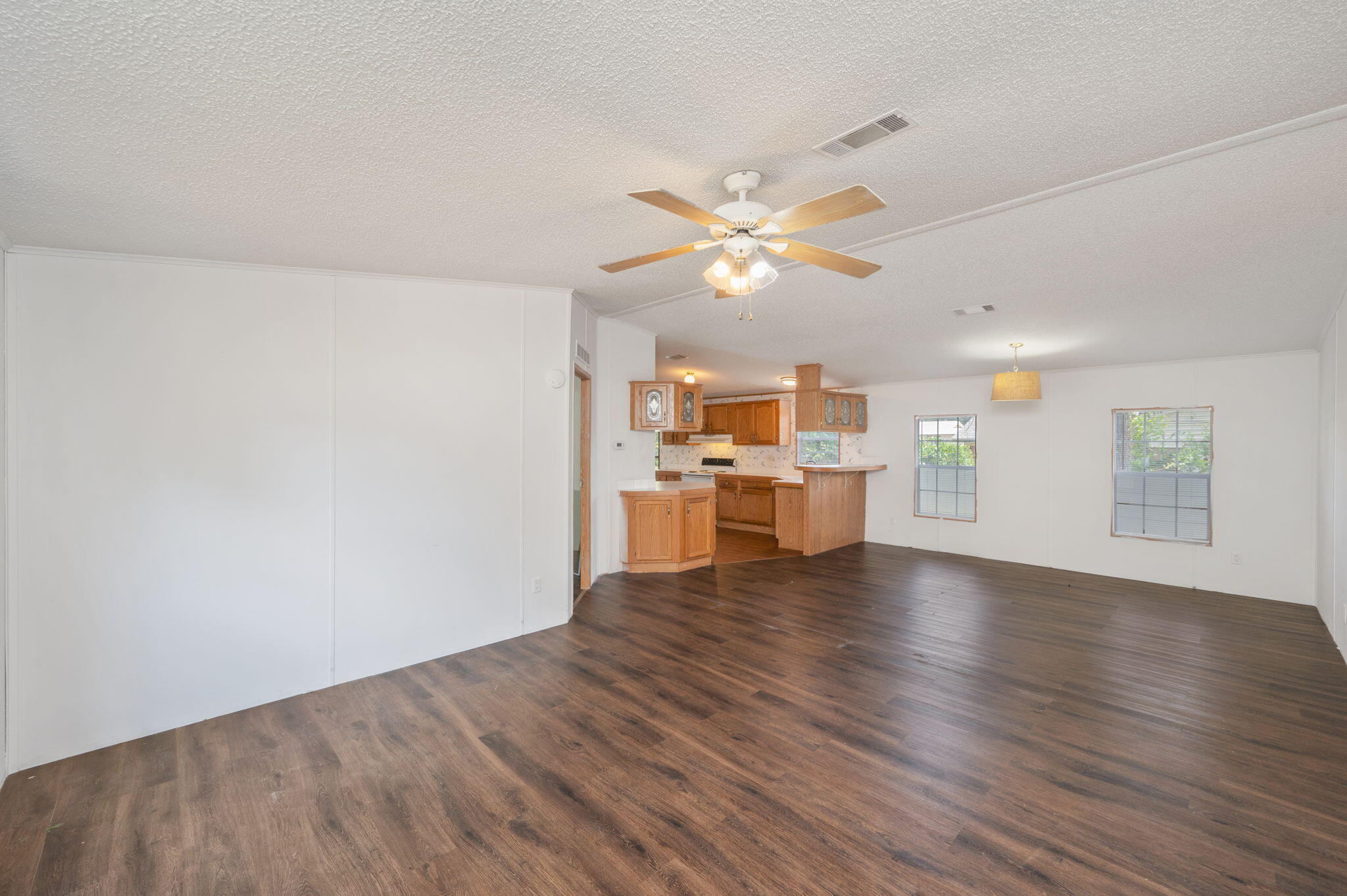 189 Benjamin Street Crestview, FL 32536 - Photo 9 of 40 a view of an empty room with wooden floor and a window