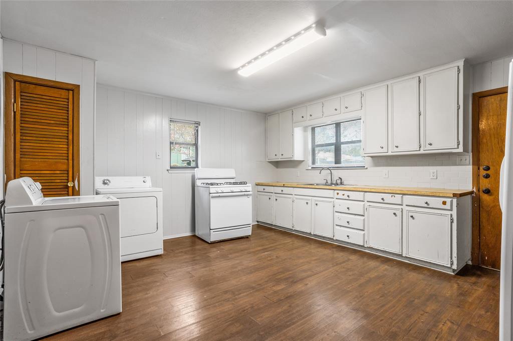 8136 Carlos Street, Unit B White Settlement, TX 76108 - Photo 12 of 17 a kitchen with white cabinets sink and white appliances