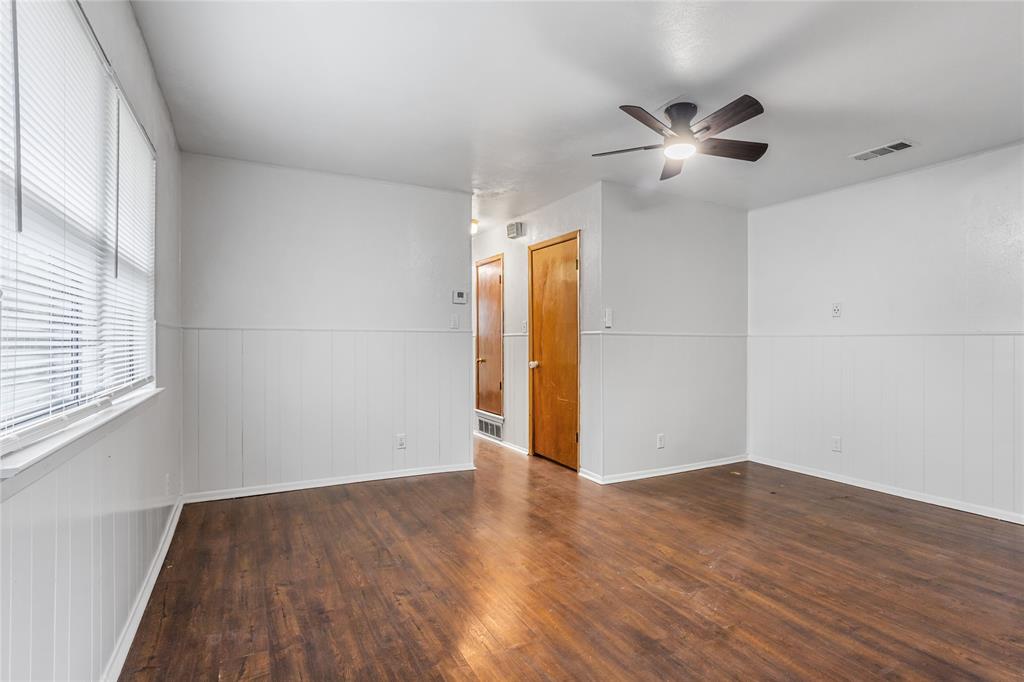 8136 Carlos Street, Unit B White Settlement, TX 76108 - Photo 7 of 17 a view of an empty room with wooden floor and a window