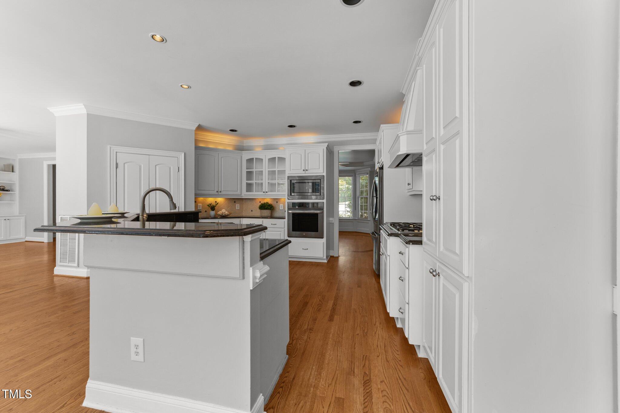 7000 Millstone Ridge Court Raleigh, NC 27614 - Photo 11 of 70 a kitchen with stainless steel appliances a sink stove and cabinets