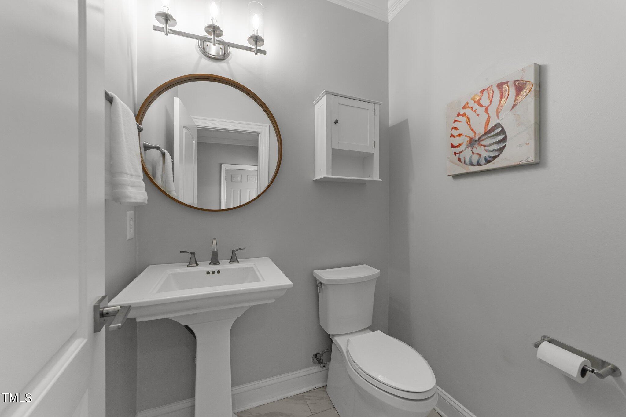 7000 Millstone Ridge Court Raleigh, NC 27614 - Photo 16 of 70 a white toilet sitting next to a bathroom sink