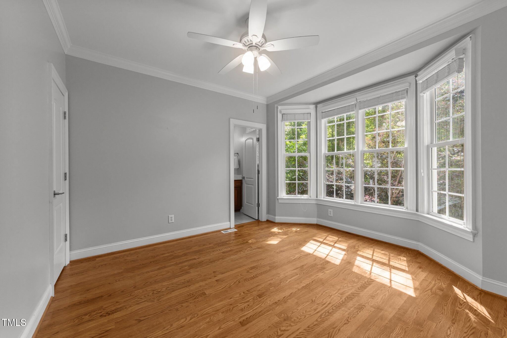 7000 Millstone Ridge Court Raleigh, NC 27614 - Photo 17 of 70 a view of an empty room with a window and a ceiling fan