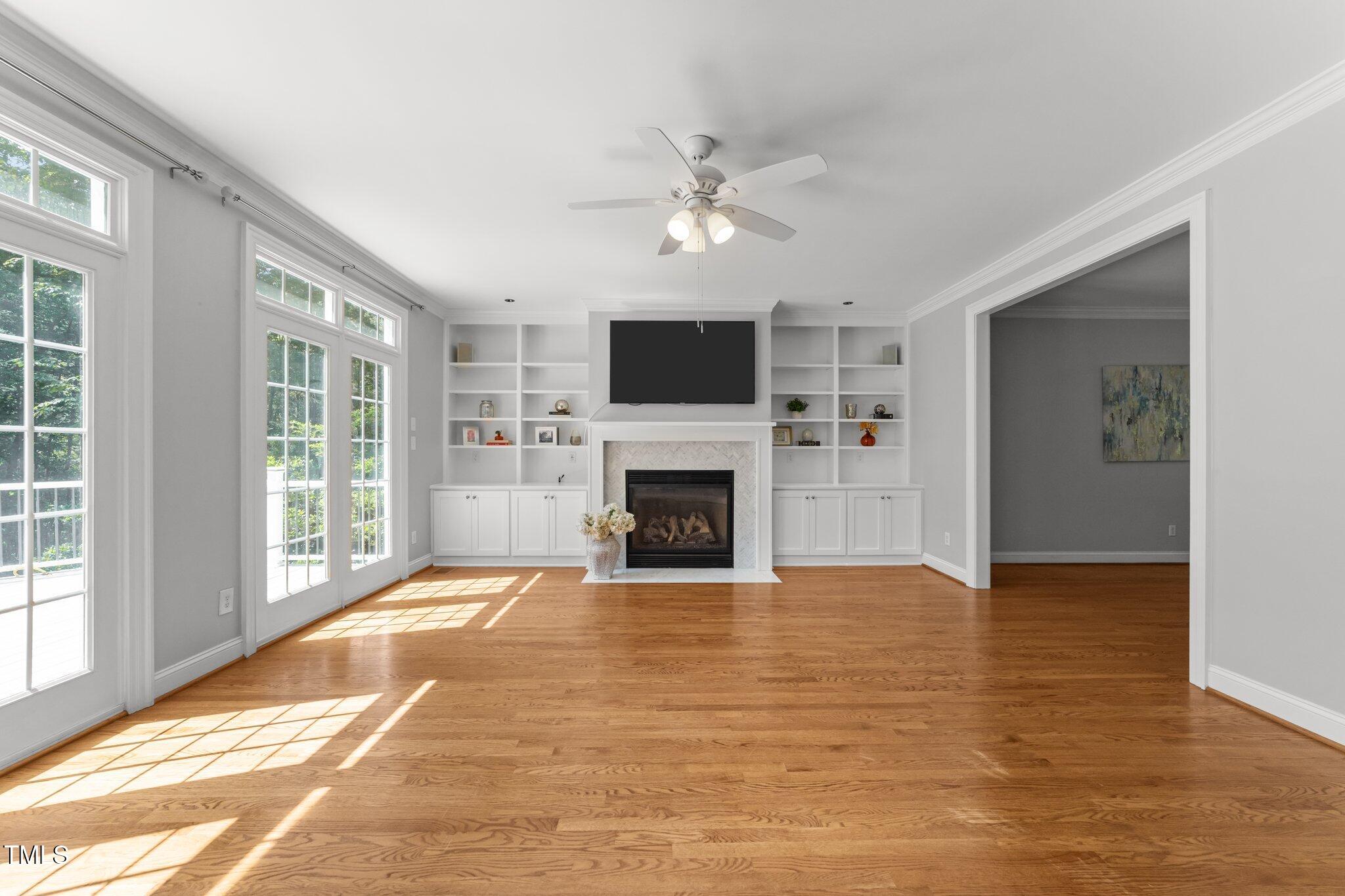 7000 Millstone Ridge Court Raleigh, NC 27614 - Photo 20 of 70 a view of a livingroom with a fireplace a ceiling fan and windows