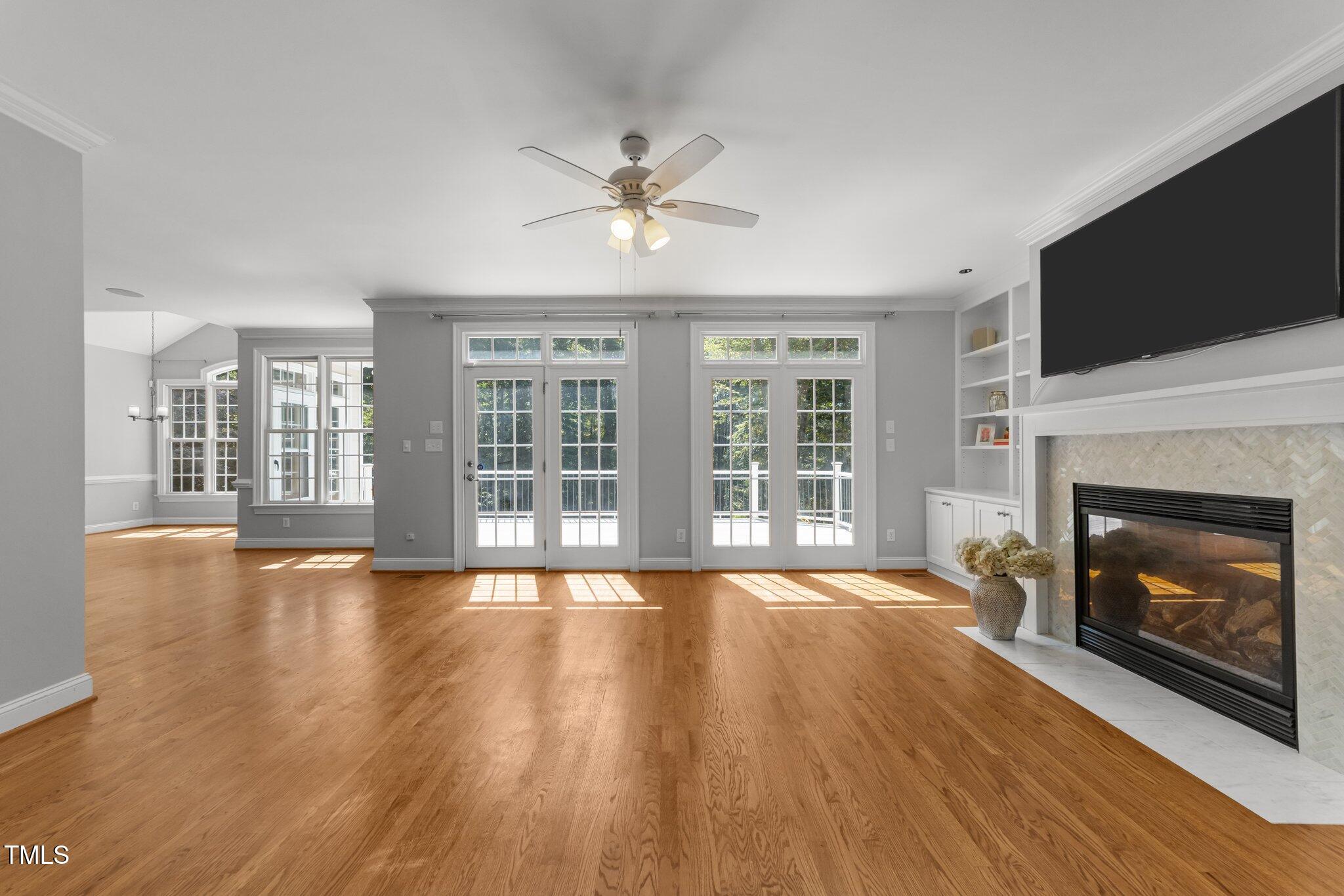 7000 Millstone Ridge Court Raleigh, NC 27614 - Photo 22 of 70 a view of an empty room with wooden floor and a fireplace