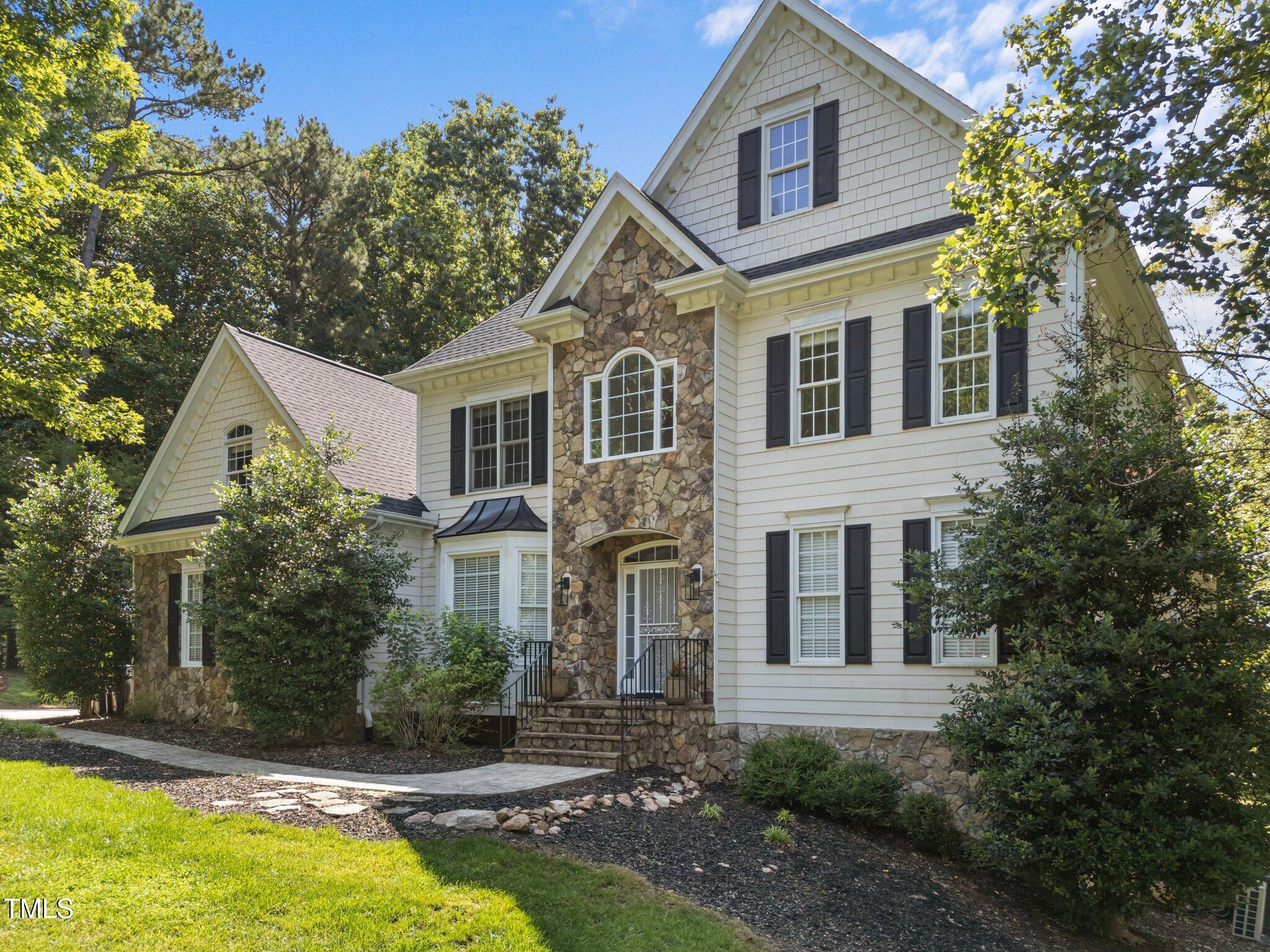 7000 Millstone Ridge Court Raleigh, NC 27614 - Photo 3 of 70 a front view of a house with a yard and garage