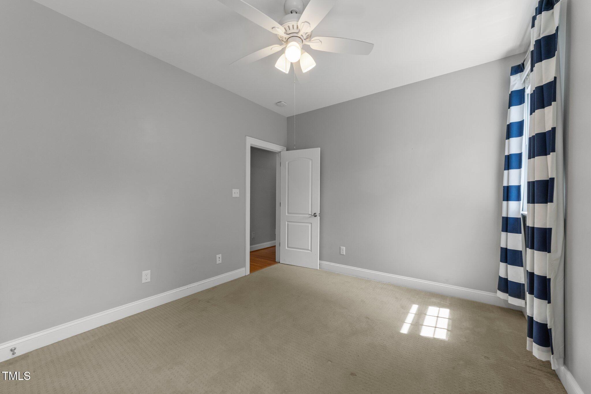7000 Millstone Ridge Court Raleigh, NC 27614 - Photo 32 of 70 a view of an empty room with a ceiling fan and window
