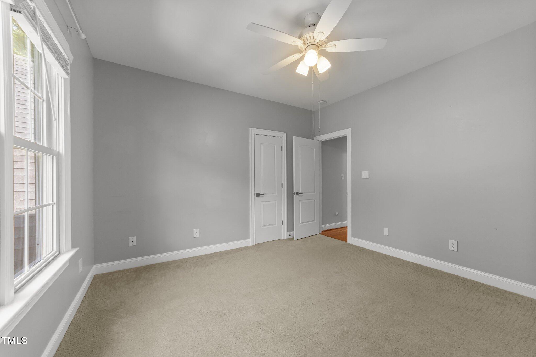 7000 Millstone Ridge Court Raleigh, NC 27614 - Photo 34 of 70 an empty room with a window and a fan
