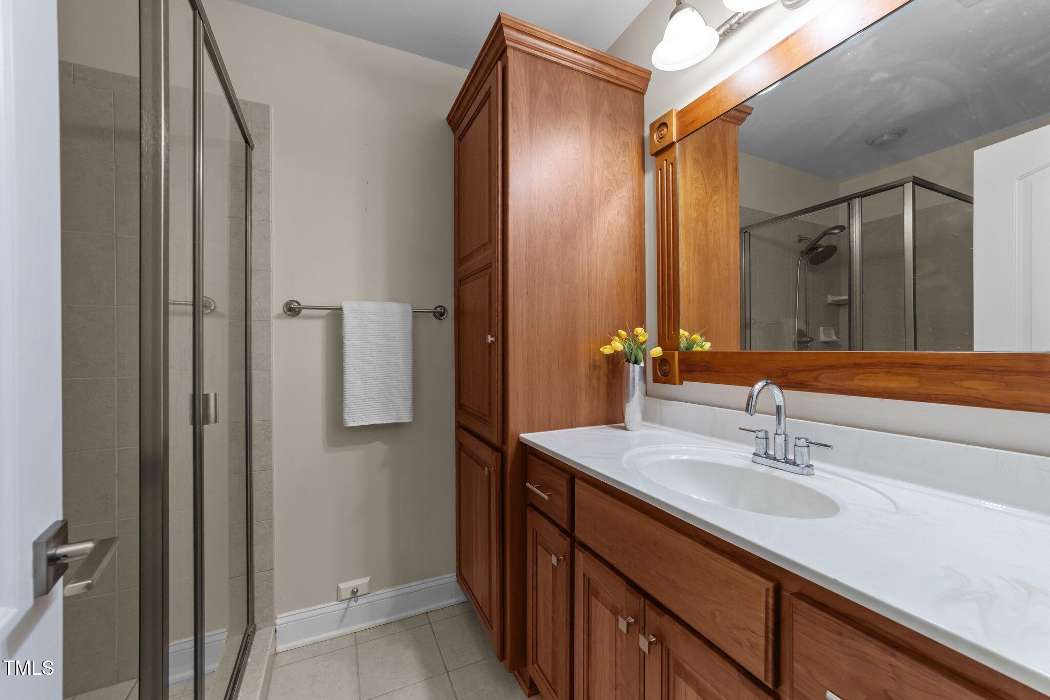 7000 Millstone Ridge Court Raleigh, NC 27614 - Photo 46 of 70 a bathroom with a double vanity sink and a mirror