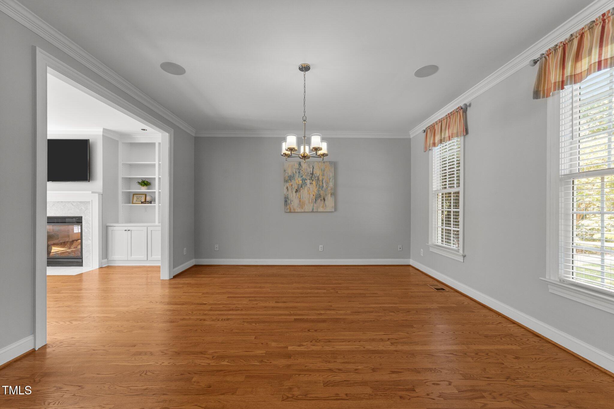 7000 Millstone Ridge Court Raleigh, NC 27614 - Photo 9 of 70 a view of an empty room with window and wooden floor