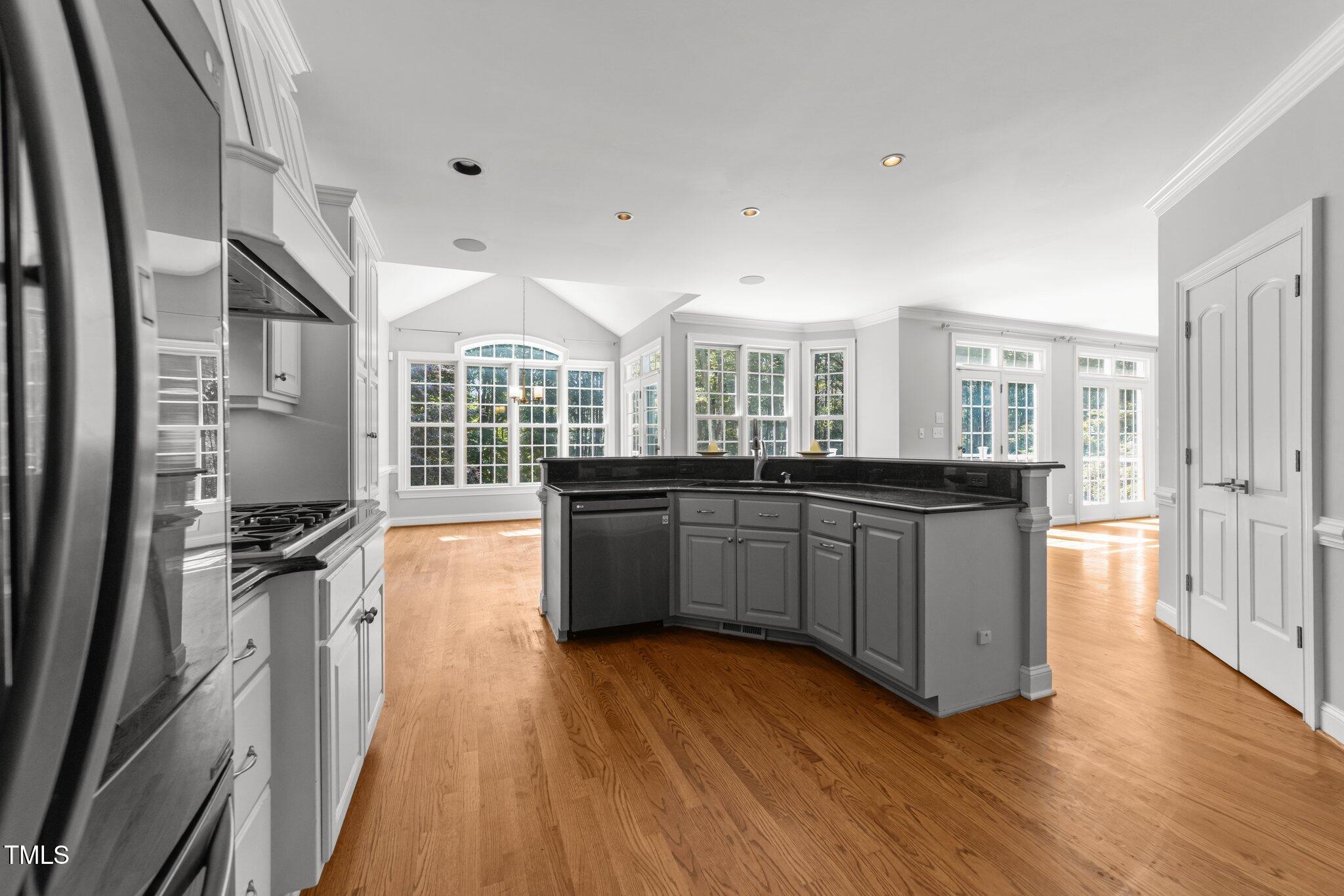 7000 Millstone Ridge Court Raleigh, NC 27614 - Photo 10 of 70 a large kitchen with a wooden floor and a large window
