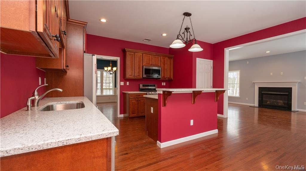 5 Harrier Ridge Drive Wallkill, NY 12589 - Photo 32 of 33 Kitchen featuring recessed lighting, a chandelier, hanging light fixtures, a breakfast bar, and open floor plan
