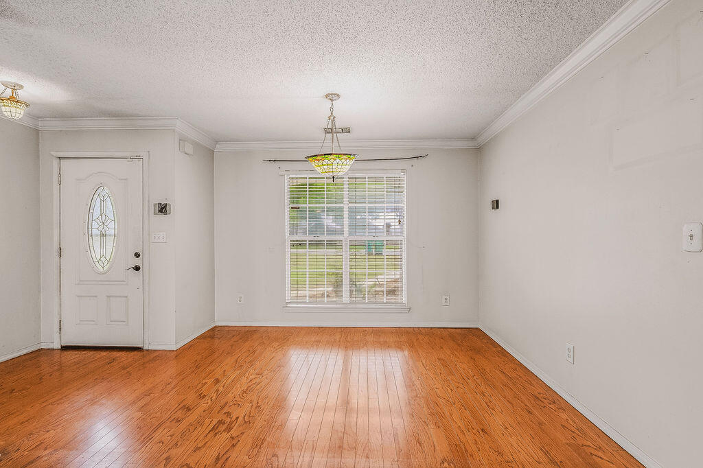 53 4th Street Shalimar, FL 32579 - Photo 8 of 47 a view of an empty room with wooden floor and a window