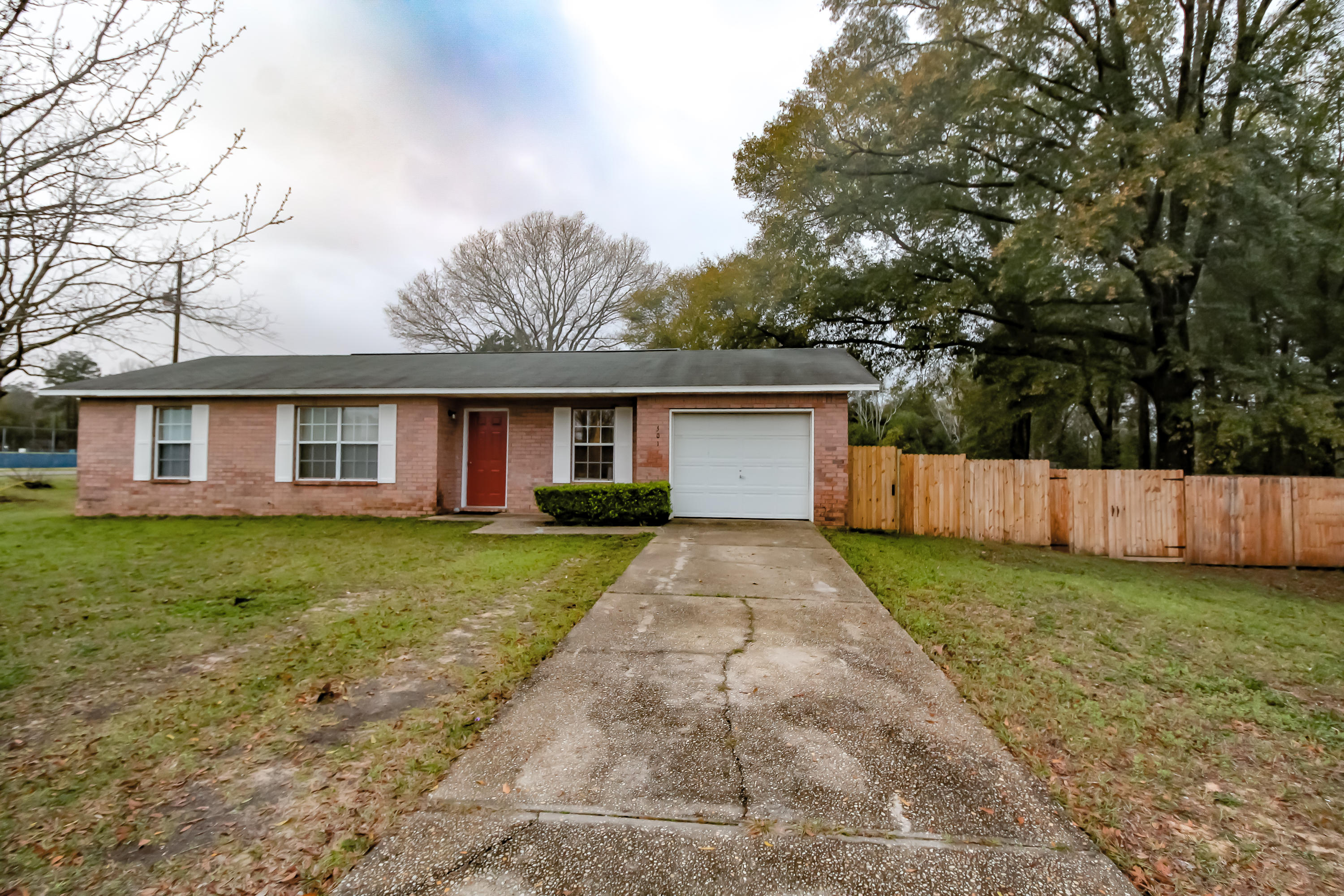 501 Anderson Street Crestview, FL 32536 - Photo 2 of 10 a front view of a house with a yard and trees