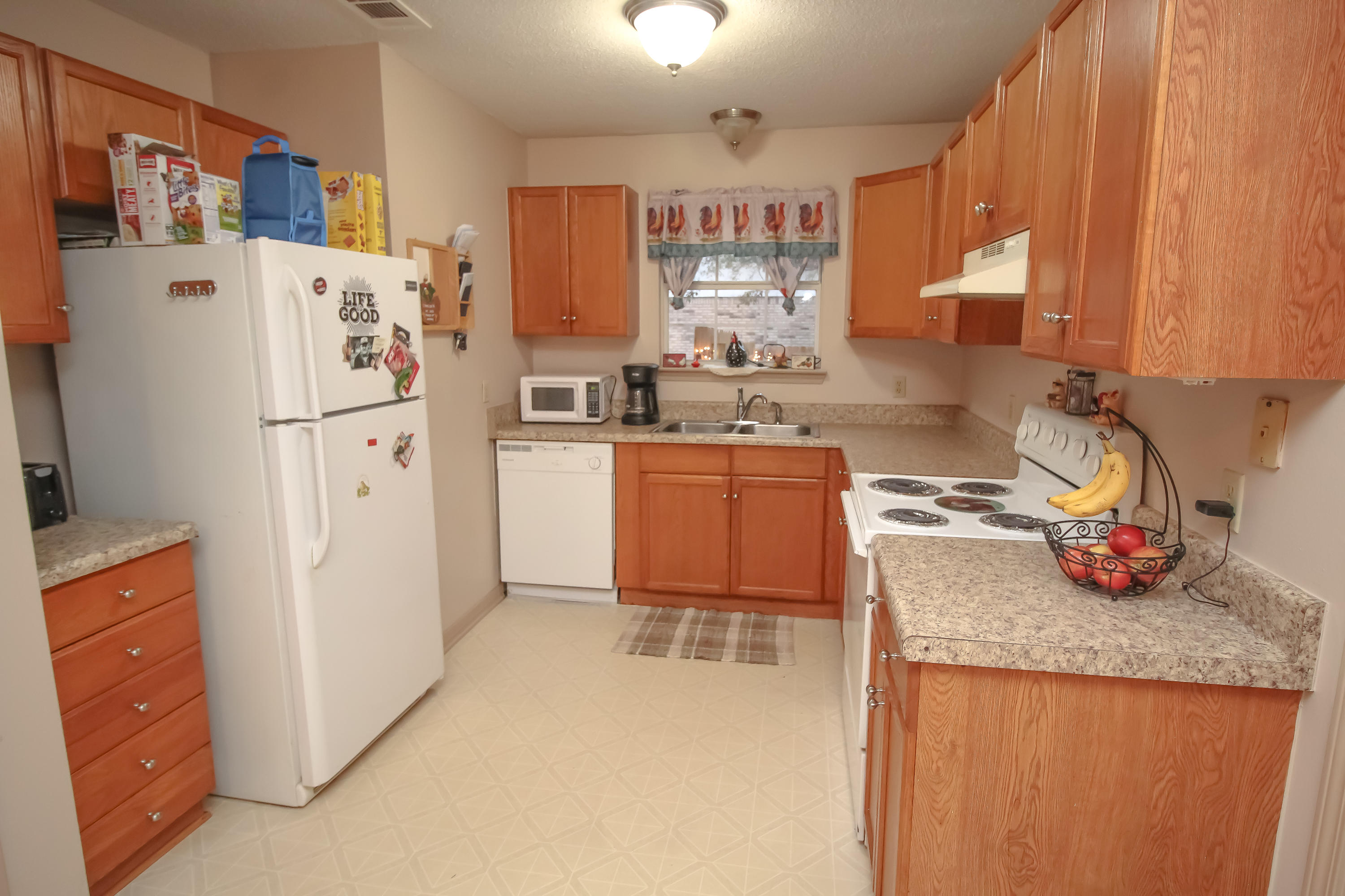 501 Anderson Street Crestview, FL 32536 - Photo 4 of 10 a kitchen with stainless steel appliances granite countertop a refrigerator a stove and a sink