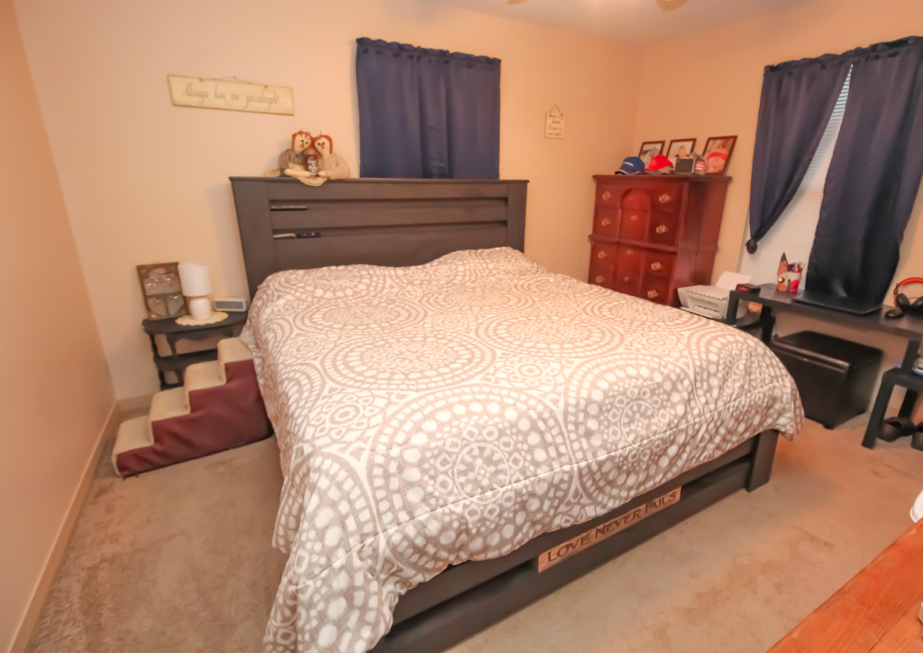 501 Anderson Street Crestview, FL 32536 - Photo 7 of 10 a bed sitting in a bedroom next to a flat screen tv and dresser