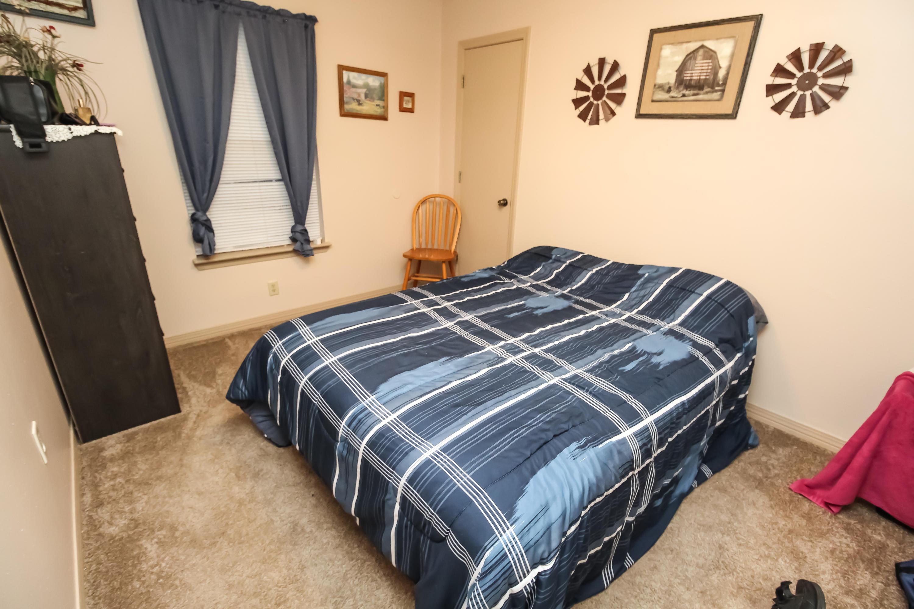 501 Anderson Street Crestview, FL 32536 - Photo 8 of 10 a bedroom with a bed and wooden floor