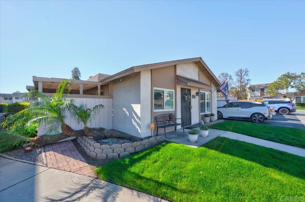 a front view of house with a garden and patio