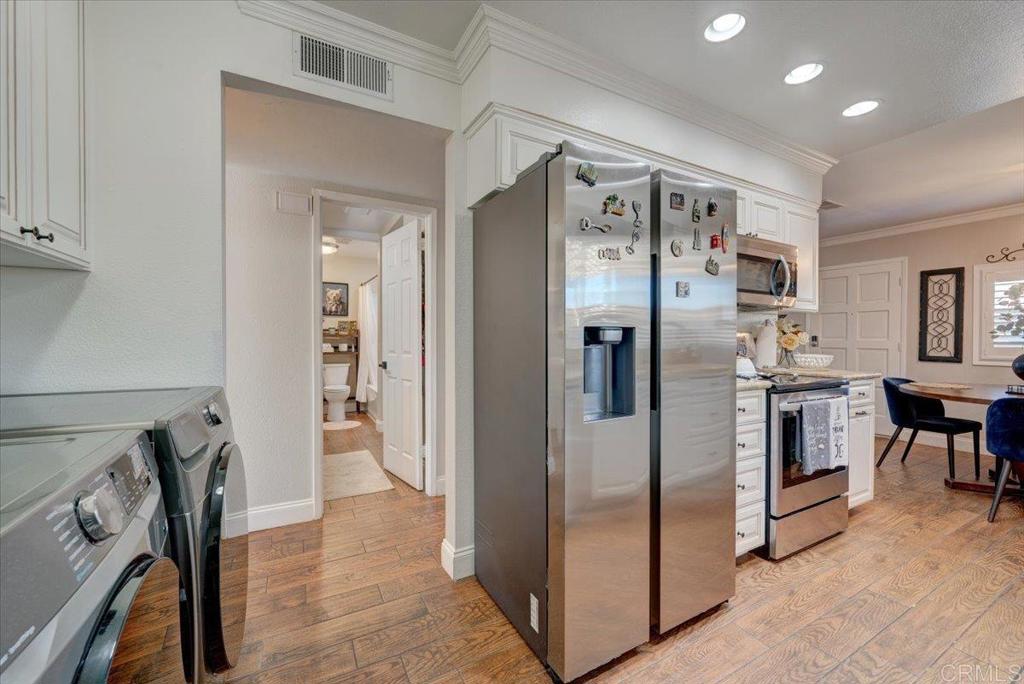 10321 Santana Ranch Drive Santee, CA 92071 - Photo 11 of 28 a kitchen with stainless steel appliances a refrigerator and a stove
