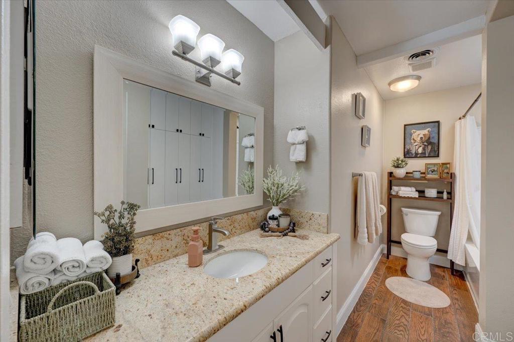 10321 Santana Ranch Drive Santee, CA 92071 - Photo 13 of 28 a spacious bathroom with a granite countertop sink and a mirror