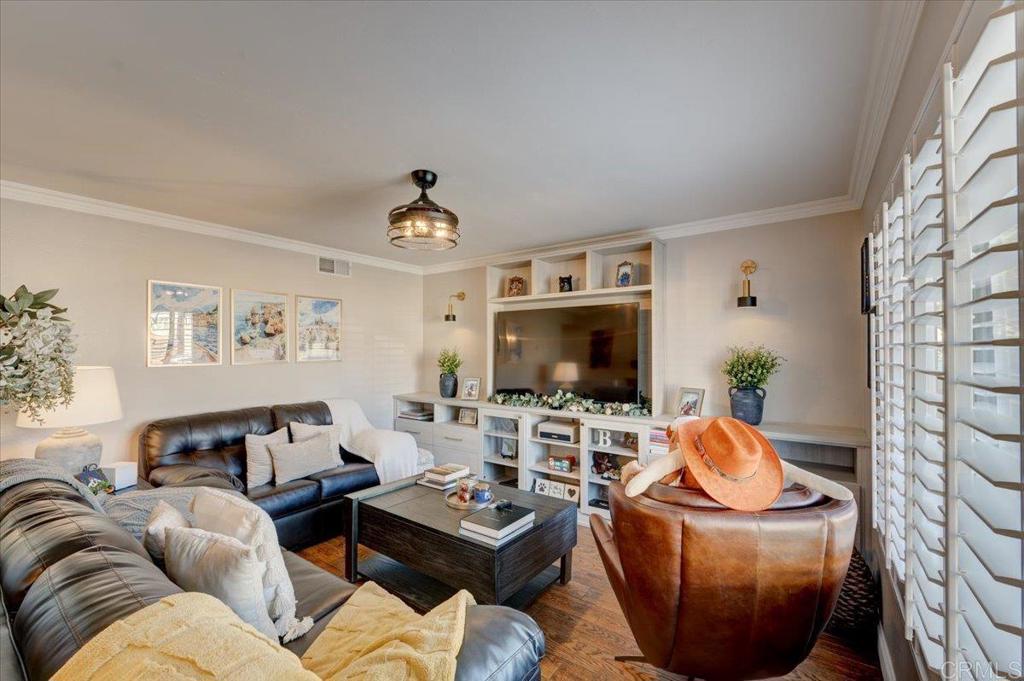 10321 Santana Ranch Drive Santee, CA 92071 - Photo 4 of 28 a living room with furniture a flat screen tv and a fireplace