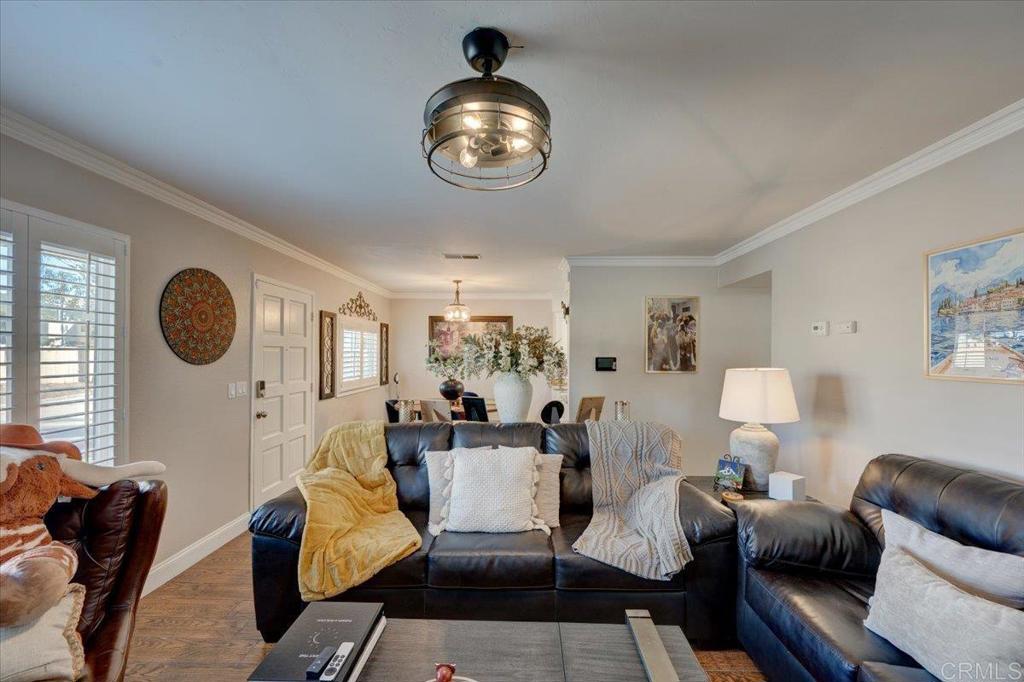 10321 Santana Ranch Drive Santee, CA 92071 - Photo 6 of 28 a living room with furniture chandelier and a mirror