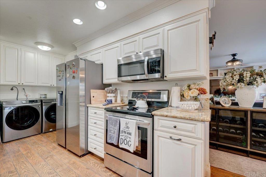 10321 Santana Ranch Drive Santee, CA 92071 - Photo 7 of 28 a kitchen with stainless steel appliances granite countertop a stove a sink and a refrigerator