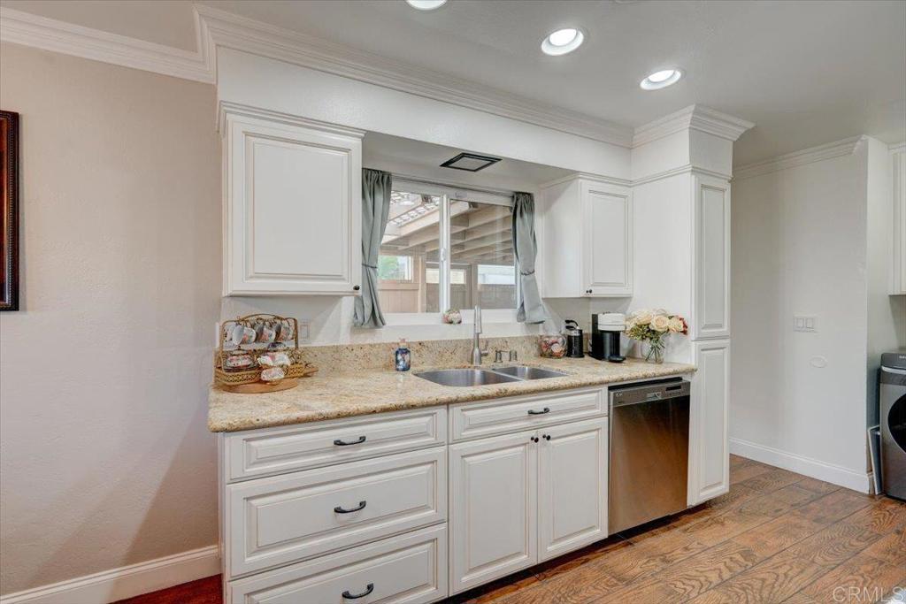 10321 Santana Ranch Drive Santee, CA 92071 - Photo 9 of 28 a kitchen with a sink window and cabinets