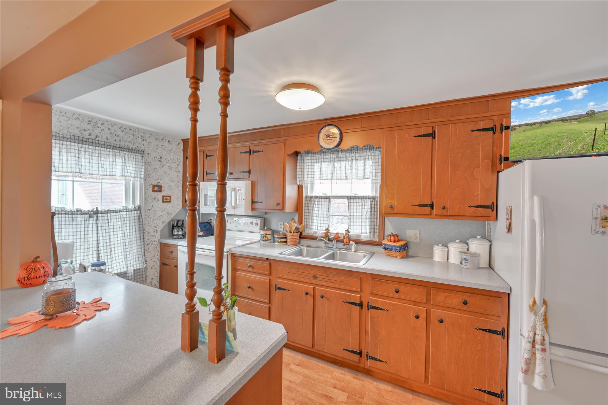 223 Lemon Street Elizabethtown, PA 17022 - Photo 18 of 31 a large kitchen with a refrigerator a sink dishwasher a stove and white cabinets with wooden floor