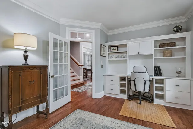 a view of a workspace with furniture and wooden floor