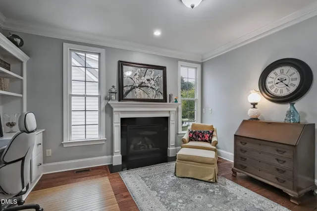 a living room with furniture a fireplace and a window