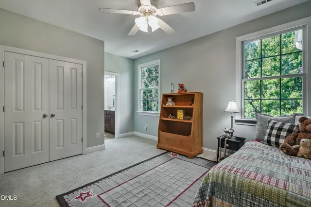 a bedroom with bed and a window