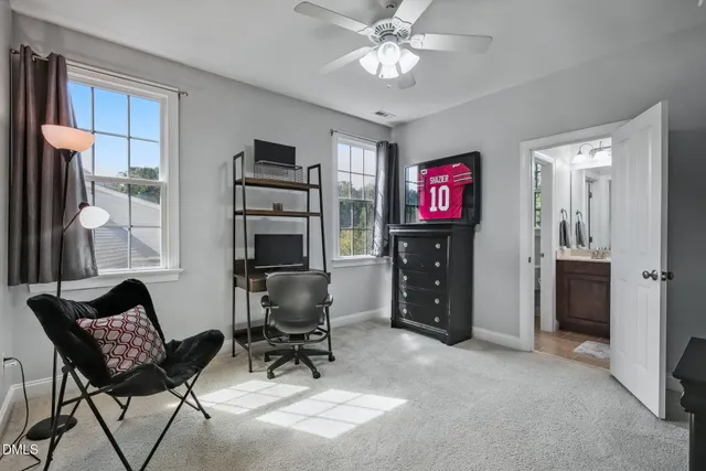 a view of a workspace with furniture and a window
