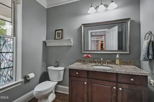 a bathroom with a toilet a sink and a mirror