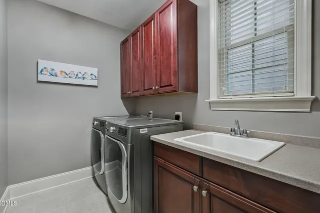 a utility room with a sink washer and dryer