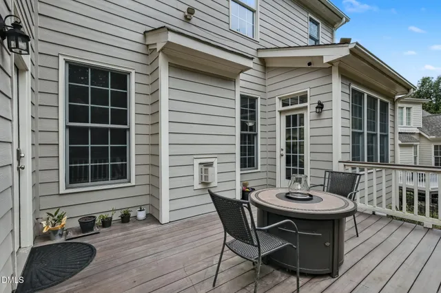 a view of a patio with table and chairs and wooden floor