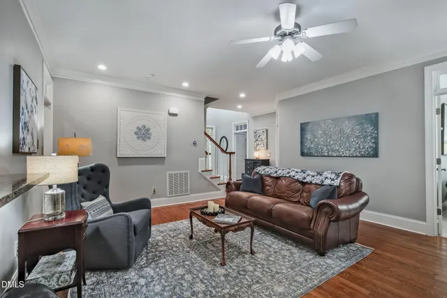 a living room with furniture and a chandelier