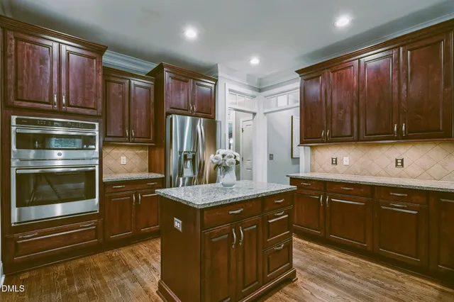 a kitchen with a sink refrigerator and microwave
