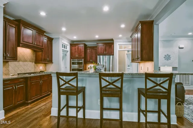 a view of a a dining room kitchen with furniture and wooden floor