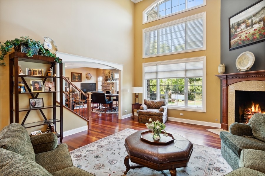 4050 Douglas Road Downers Grove, IL 60515 - Photo 11 of 60 a living room with fireplace furniture and a floor to ceiling window