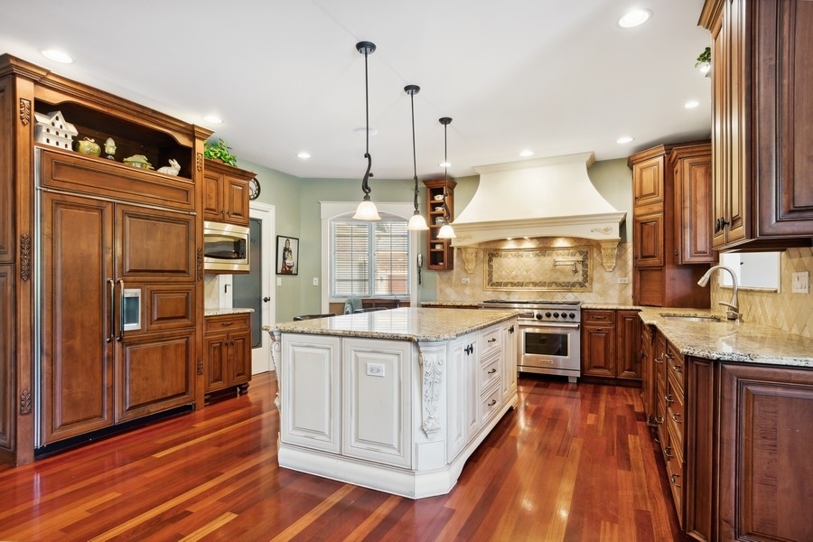 4050 Douglas Road Downers Grove, IL 60515 - Photo 15 of 60 a kitchen with stainless steel appliances granite countertop a stove a refrigerator a sink and dishwasher with wooden floor