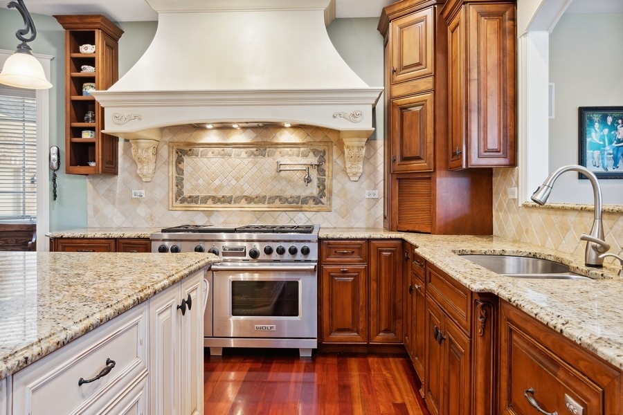 4050 Douglas Road Downers Grove, IL 60515 - Photo 18 of 60 a kitchen with granite countertop a sink stove and cabinets