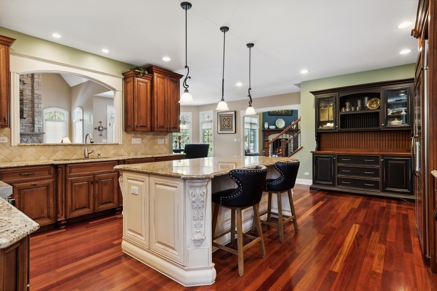 4050 Douglas Road Downers Grove, IL 60515 - Photo 19 of 60 a kitchen with stainless steel appliances granite countertop a stove top oven a sink dishwasher and a wooden cabinets