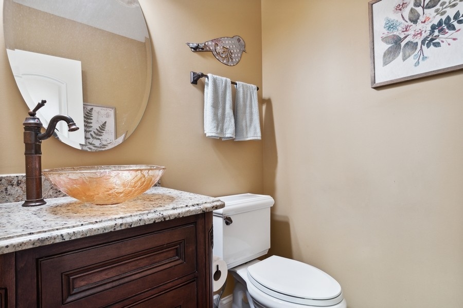 4050 Douglas Road Downers Grove, IL 60515 - Photo 23 of 60 a bathroom with a granite countertop toilet sink and mirror