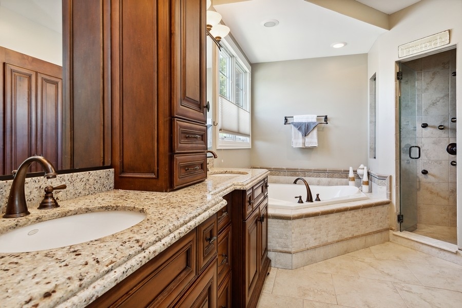 4050 Douglas Road Downers Grove, IL 60515 - Photo 26 of 60 a bathroom with a granite countertop tub sink and mirror