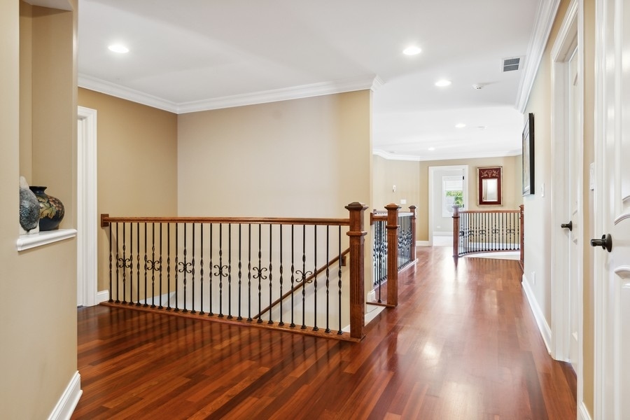 4050 Douglas Road Downers Grove, IL 60515 - Photo 28 of 60 a view of a hallway with wooden floor and windows